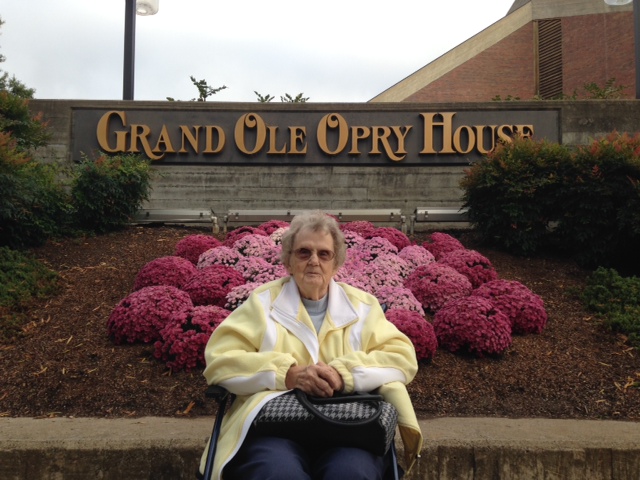Irene Dobelmann sitting in front of the Grand Ole Opry House