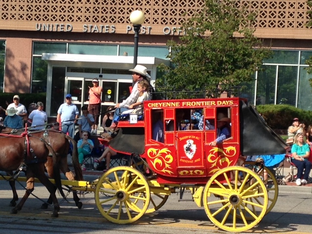Red horse-drawn wagon labeled "Cheyenne Frontier Days"