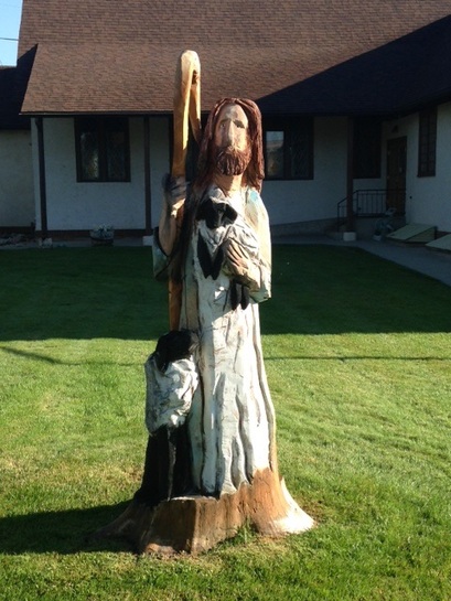 Stump carving depicting Jesus as the Good Shepherd