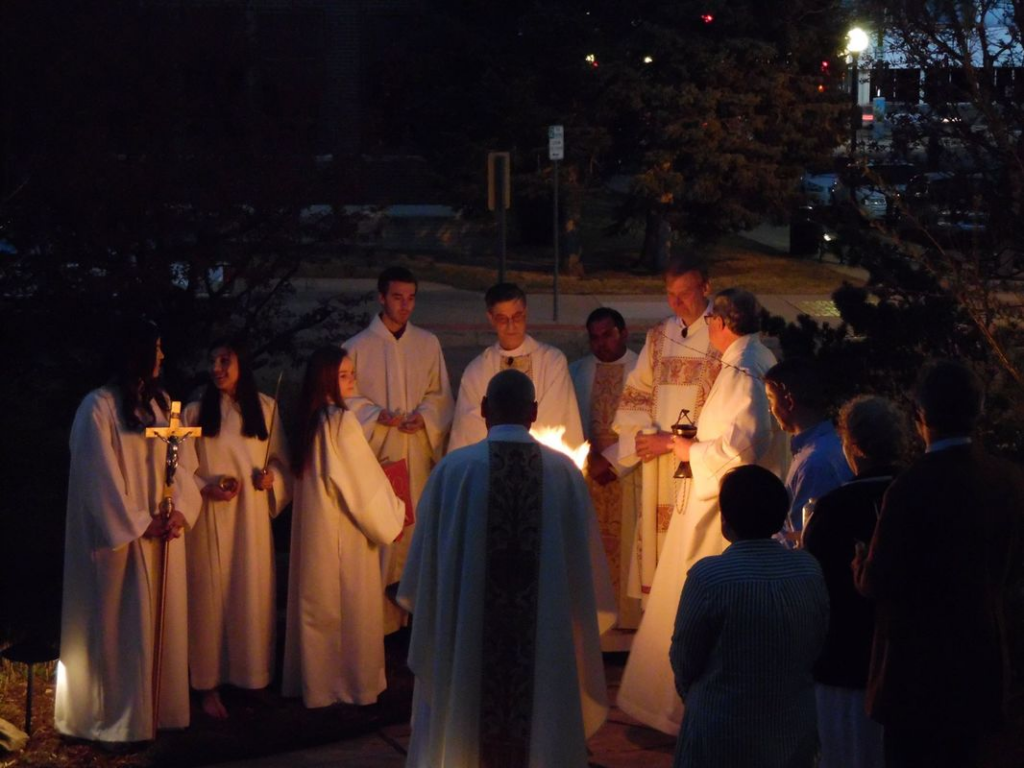 Clergy of St. Mary's Cathedral in Cheyenne, WY, standing outside around a fire during the Easter Vigil 2017